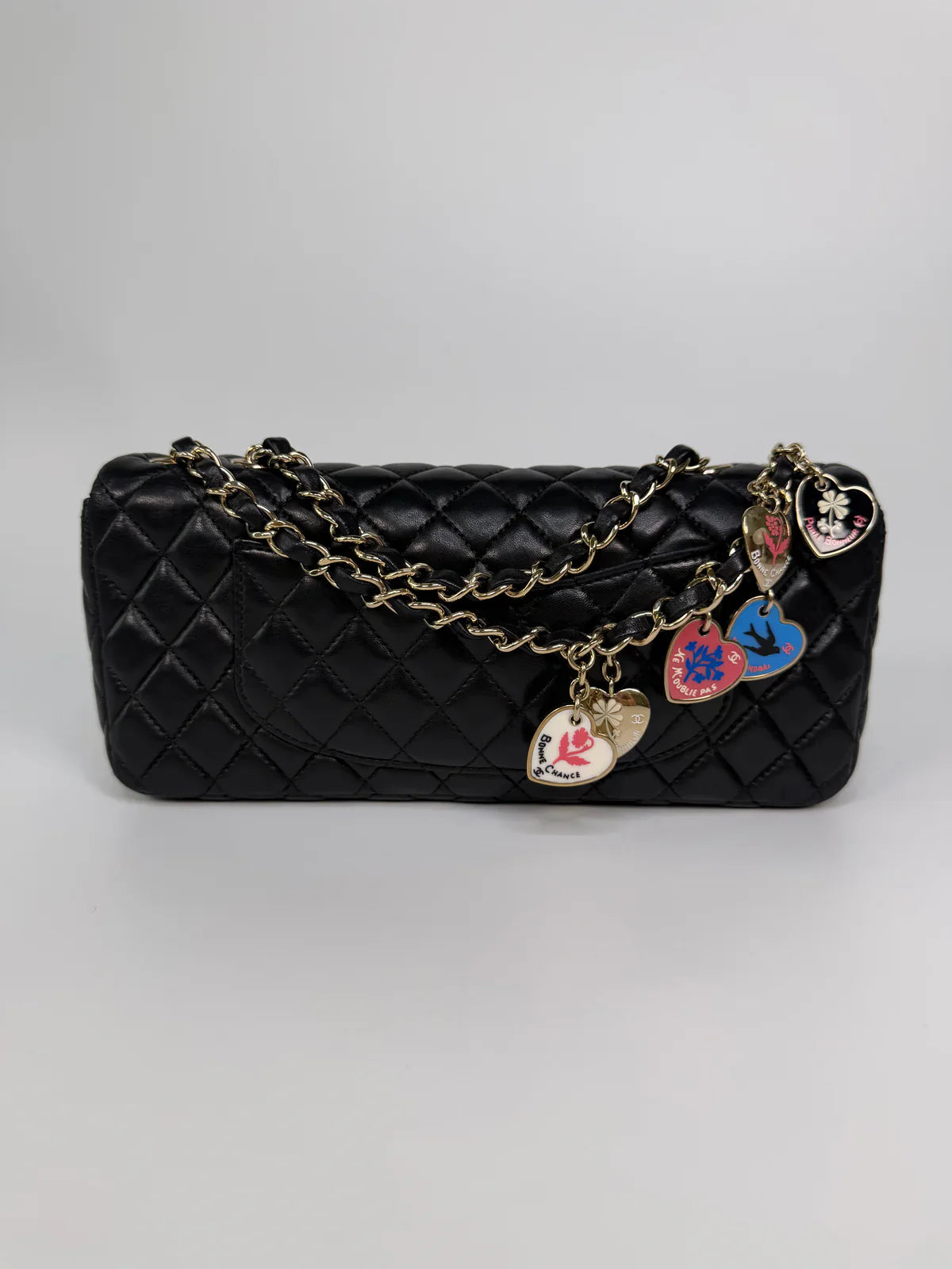 CHANEL EAST WEST CHARMS BAG IN BLACK LAMBSKIN LEATHER WITH GOLD HARDWARE