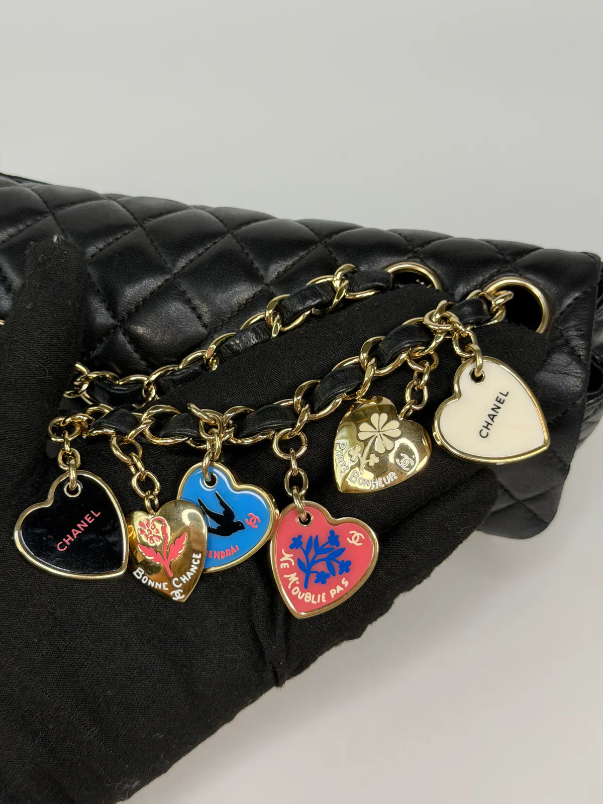 CHANEL EAST WEST CHARMS BAG IN BLACK LAMBSKIN LEATHER WITH GOLD HARDWARE